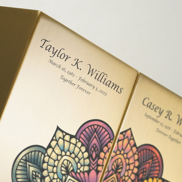 Close-up of the Mandala in Bronze Companion Urn Set by Magnolia Cremations, showcasing the intricate, colorful mandala artwork on a brushed bronze surface. The personalized engraving is elegantly displayed, adding a meaningful tribute to this contemporary cremation urn pair. A unique and artistic way to honor loved ones.
