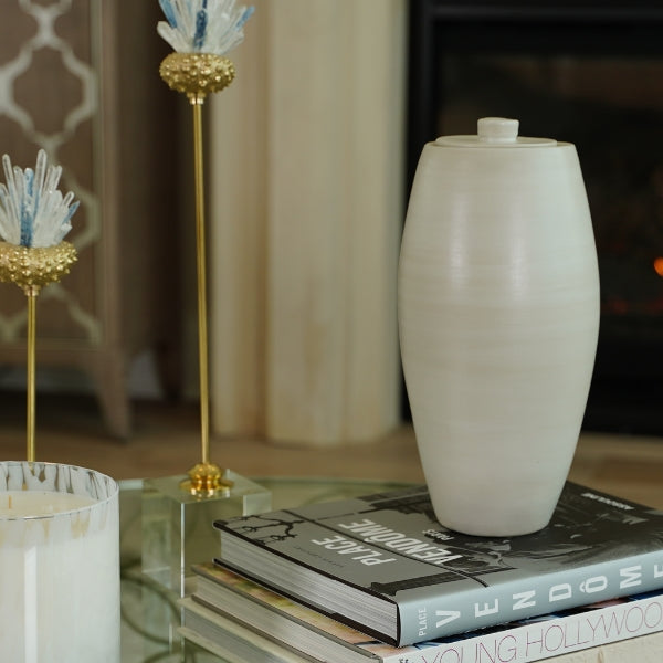 Tall urn with a smooth, curved surface and a warm beige finish. Nouveau Pure Beach.