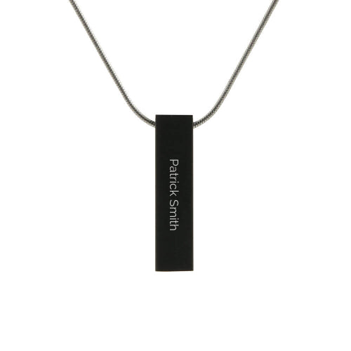 The Onyx Pillar w/ Cubic Zirconia Memorial Necklace is a modern, black stainless steel pendant with a sleek rectangular design. This version features an engraved name for personalization. The pendant has a discreet compartment for holding a small portion of ashes and includes a matching 19-inch chain.
