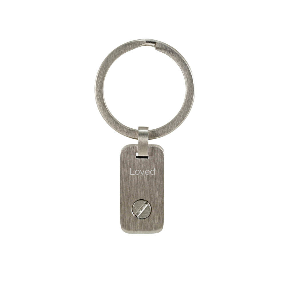 Metal keychain with a treble clef design, for holding a small memento.