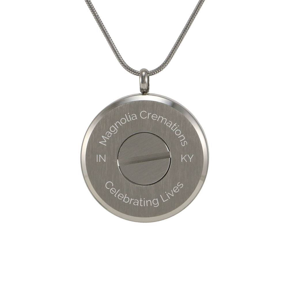 Pewter pendant with engraved circles and a delicate chain.