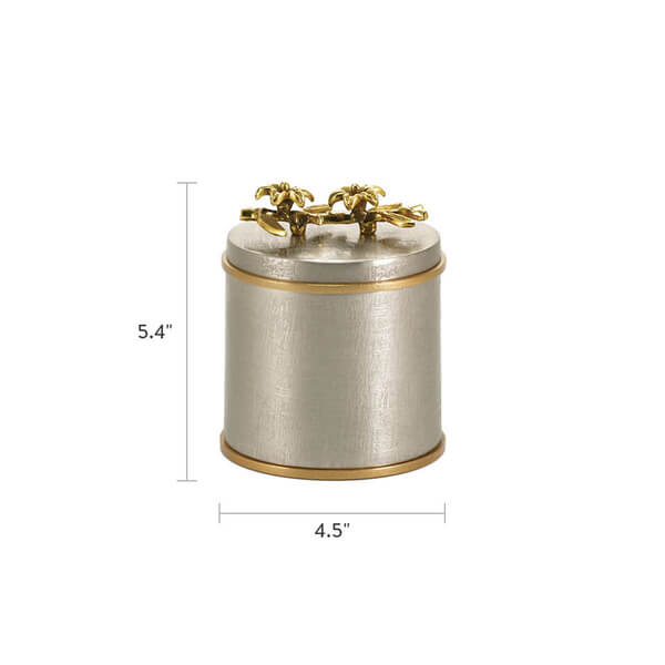 Cylindrical keepsake urn with a brushed silver finish and gold trim, featuring two gold sculpted flowers on the lid. Dimensions are shown: 5.4 inches tall and 4.5 inches wide.