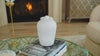 Rounded urn with a smooth white finish and a simple, elegant design.