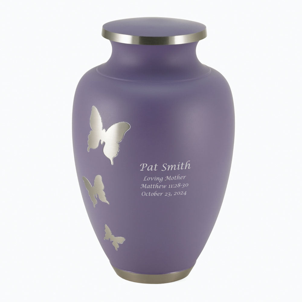 Aria® Butterfly, a full-size cremation urn. This elegant urn features a delicate butterfly design on a muted lavender finish. Made of solid brass with a secure, threaded lid. Suitable for holding the ashes of an adult.